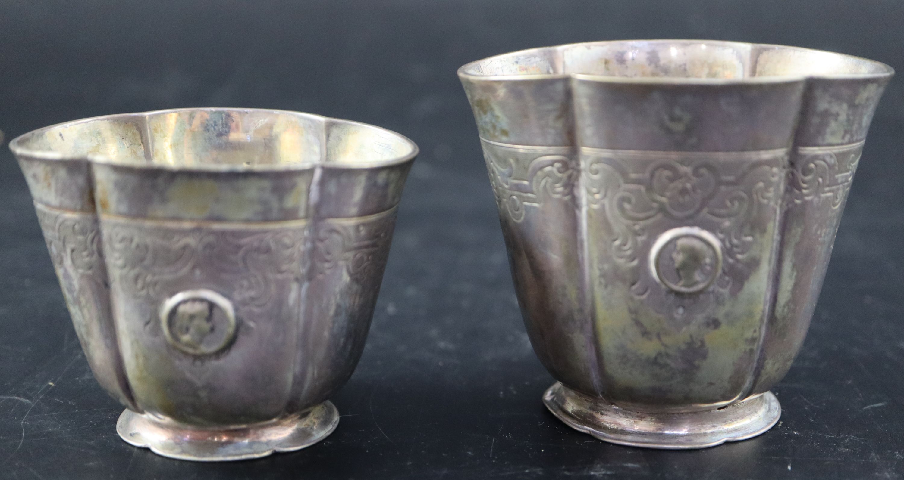 A graduated pair of Continental white metal cusped small vases, tallest 7cm, 215 grams
